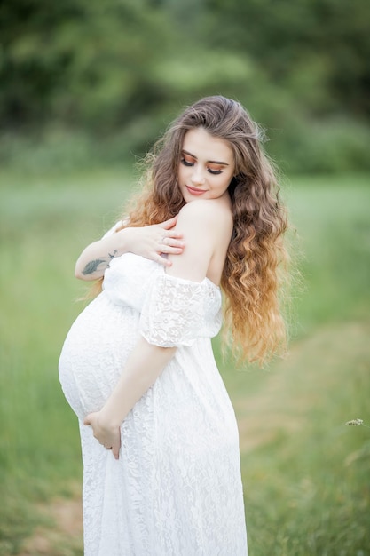 A beautiful young pregnant woman posing