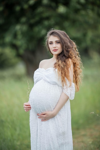 A beautiful young pregnant woman posing