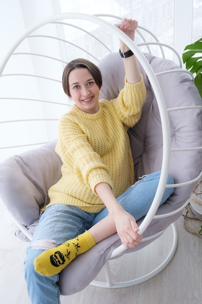 Beautiful young pregnant woman relaxing at home