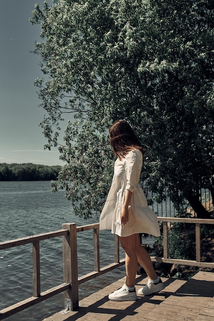 Beautiful young romantic girl in a park by the river, natural beauty, naturalness, eco rest.