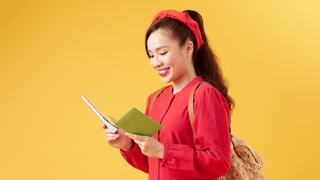 Beautiful young smiling girl holds tickets for travel Rest travel tour