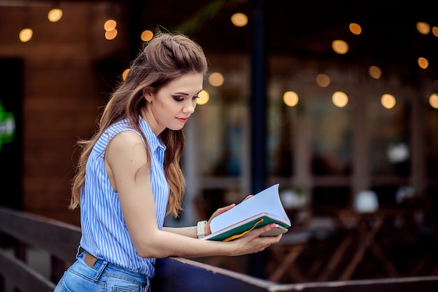 Beautiful young student girl with a book