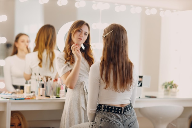 Beautiful young woman applying makeup beauty visage brush