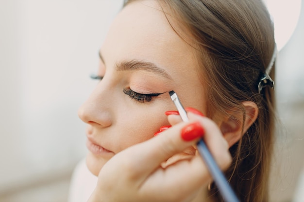 Beautiful young woman applying makeup beauty visage brush