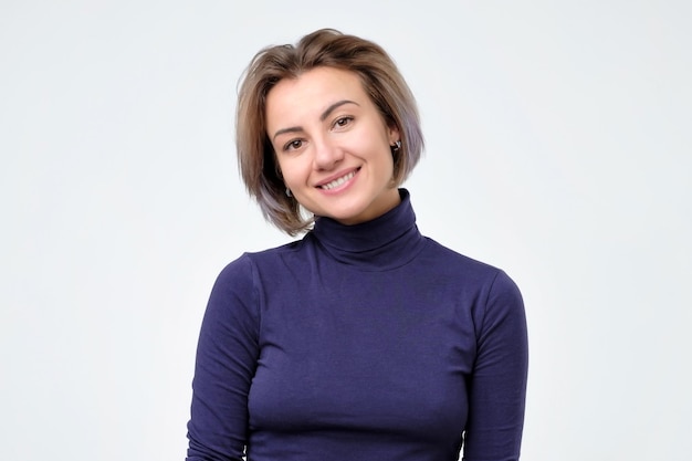 Beautiful young woman in blue clothes smiling