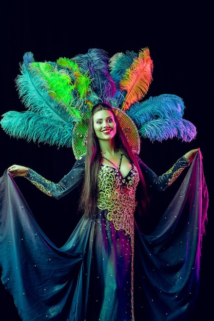 Beautiful young woman in carnival peacock costume Beauty model woman at party over holiday