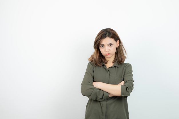 Beautiful young woman in casual outfit standing arms crossed. High quality photo