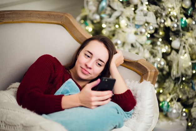 Beautiful young woman on Christmas at home