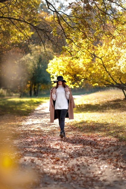 Beautiful young woman in coat and black hat