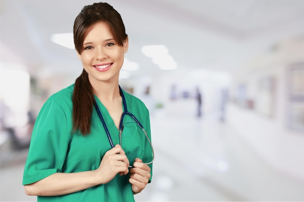 Beautiful young woman doctor smiling in work uniform