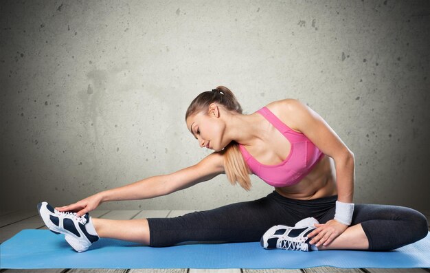 Beautiful young woman doing her workout   isolated background