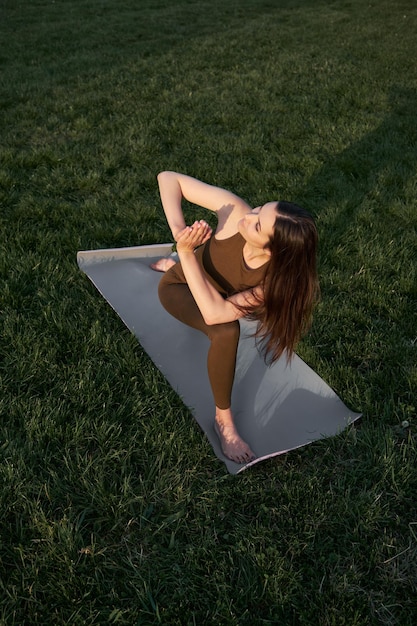 A beautiful young woman doing yoga or outdoor sports in the park