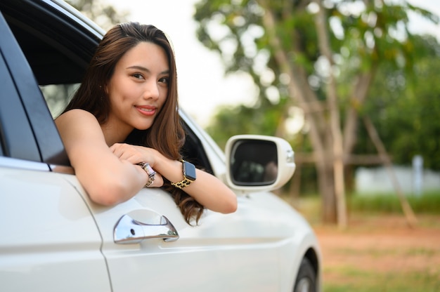 Beautiful young woman driving a car