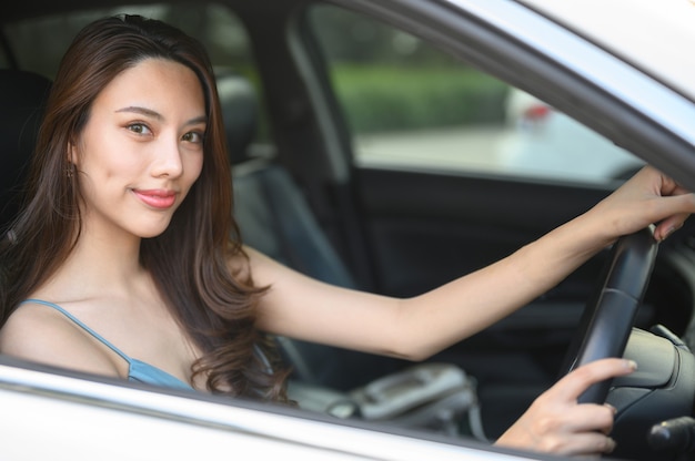 Beautiful young woman driving a car