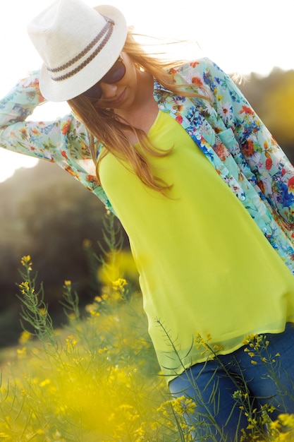 Beautiful young woman enjoying summer in a field.