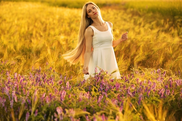 Beautiful young woman in field