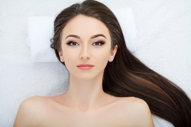 Beautiful Young Woman Getting a Face Treatment at Beauty Salon