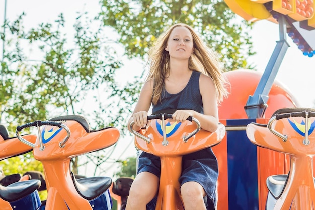 Beautiful, young woman having fun at an amusement park