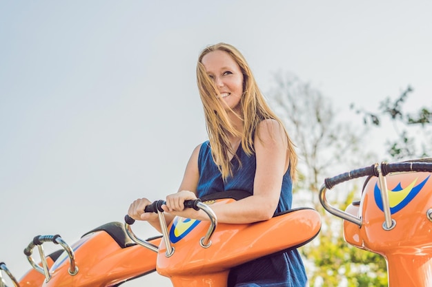 Beautiful, young woman having fun at an amusement park