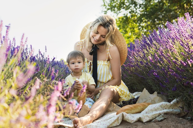 Beautiful young woman and her cute little son in the lavender field