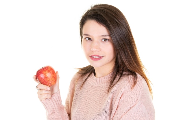 Beautiful young woman holding biting an apple red