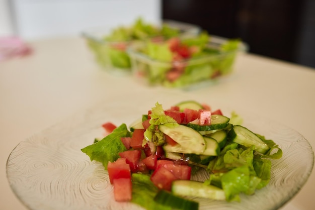 Beautiful young woman is preparing vegetable salad in the kitchen healthy food vegan salad diet diet