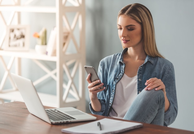 Beautiful young woman is using a smartphone.