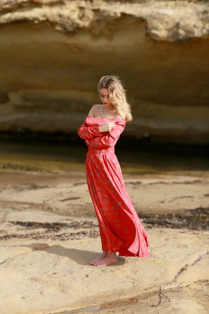 Beautiful young woman in a long dress