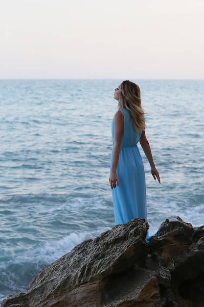 Beautiful young woman in a long dress