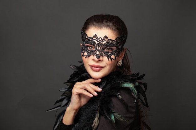 Beautiful young woman in mysterious black Venetian mask Fashion photo