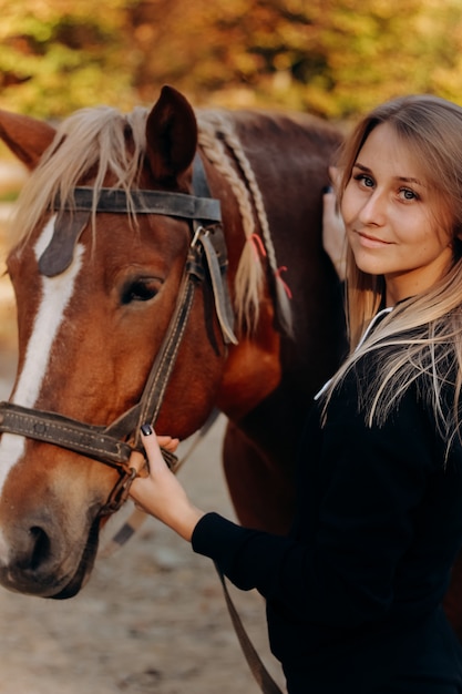 Beautiful young woman near horse