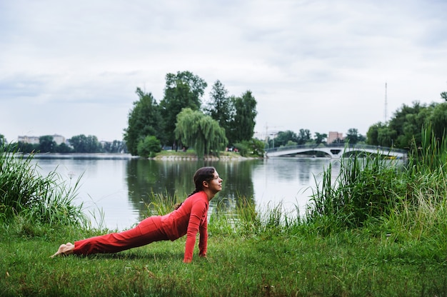 Beautiful young woman performing yoga exercises