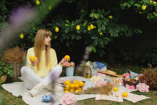 Beautiful young woman on a picnic in the garden