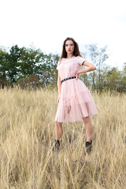 Beautiful young woman in a pink dress