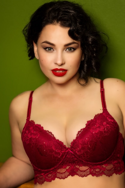 Beautiful young woman plus size in lingerie in the interior