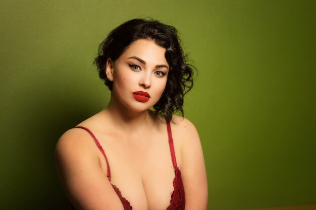 Beautiful young woman plus size in lingerie in the interior