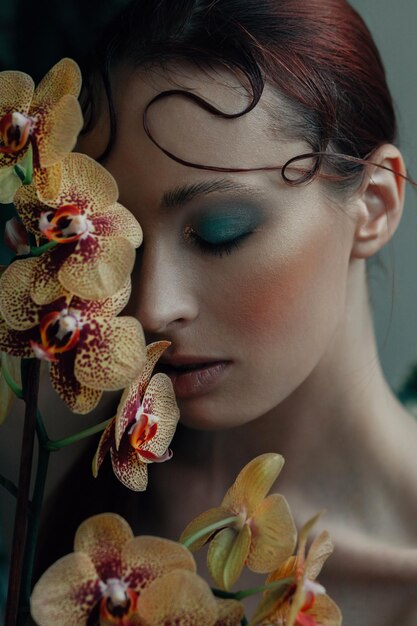 Beautiful young woman portrait with orchid