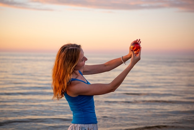 Beautiful young woman relaxing at sunset