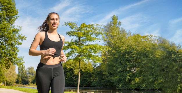 Beautiful young woman run in nature