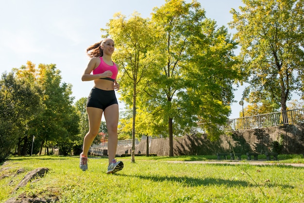 Beautiful young woman running in nature