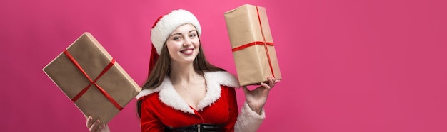 Beautiful young woman in Santa Claus costume against the red background