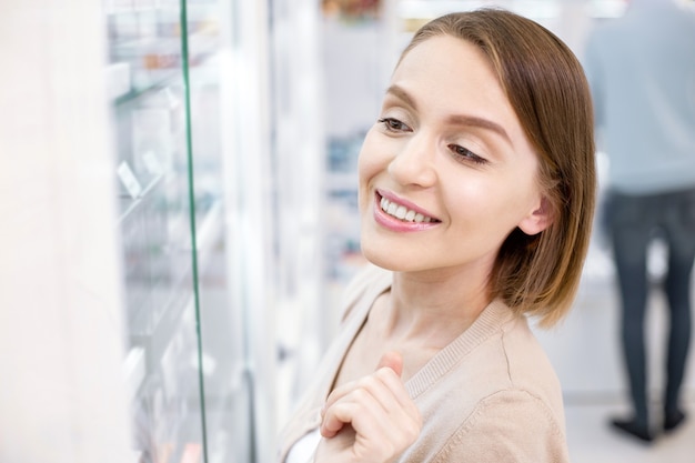 Beautiful young woman shopping in a drugstore