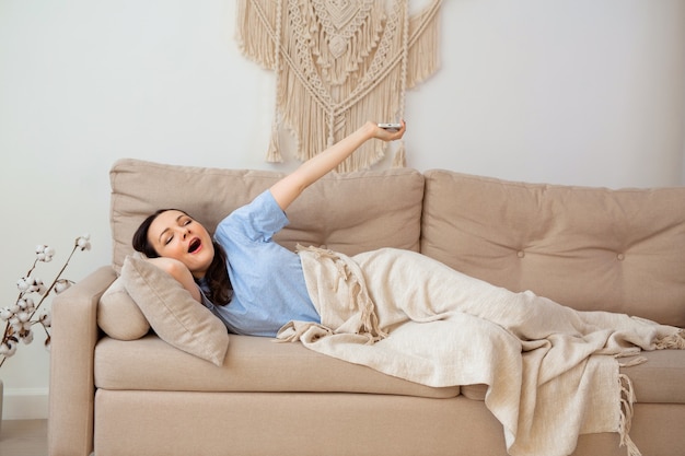 beautiful young woman sleeping on the sofa under a blanket