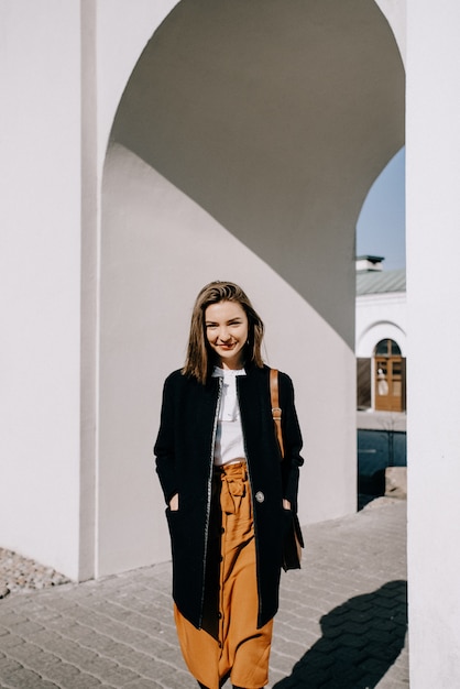 Beautiful young woman smiling. Walking in the city