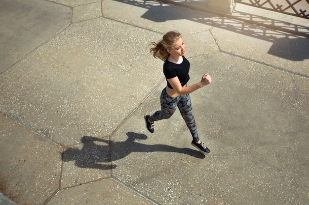 beautiful young woman in summer engaged in jogging