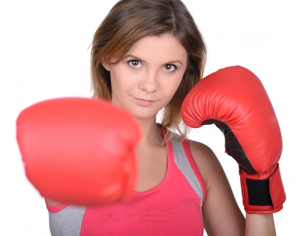 Beautiful young woman training and wearing boxing gloves