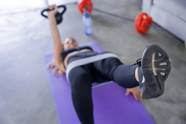 Beautiful and young woman training with elastic band