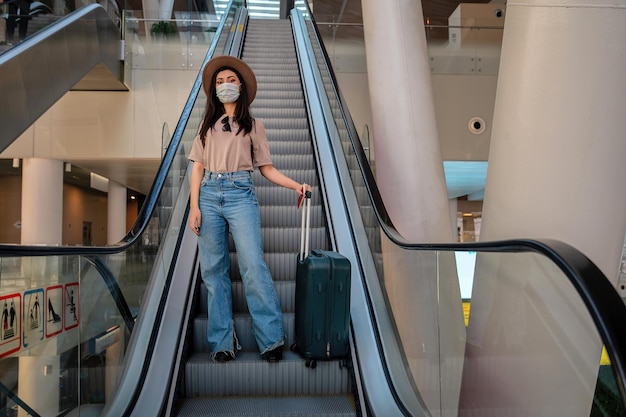 Beautiful young woman travels posing at airport during her trip