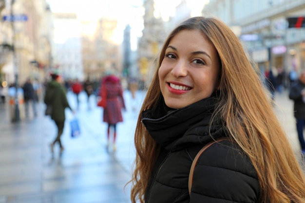 Beautiful young woman walking in Vienna main street at winter season, Austria