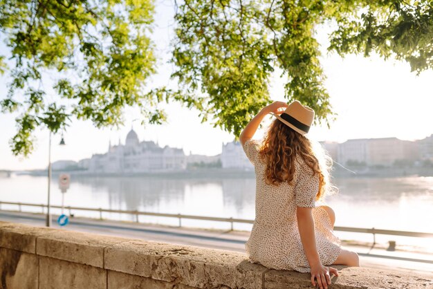 A beautiful young woman walks on the embankment Tourism relax youth nature